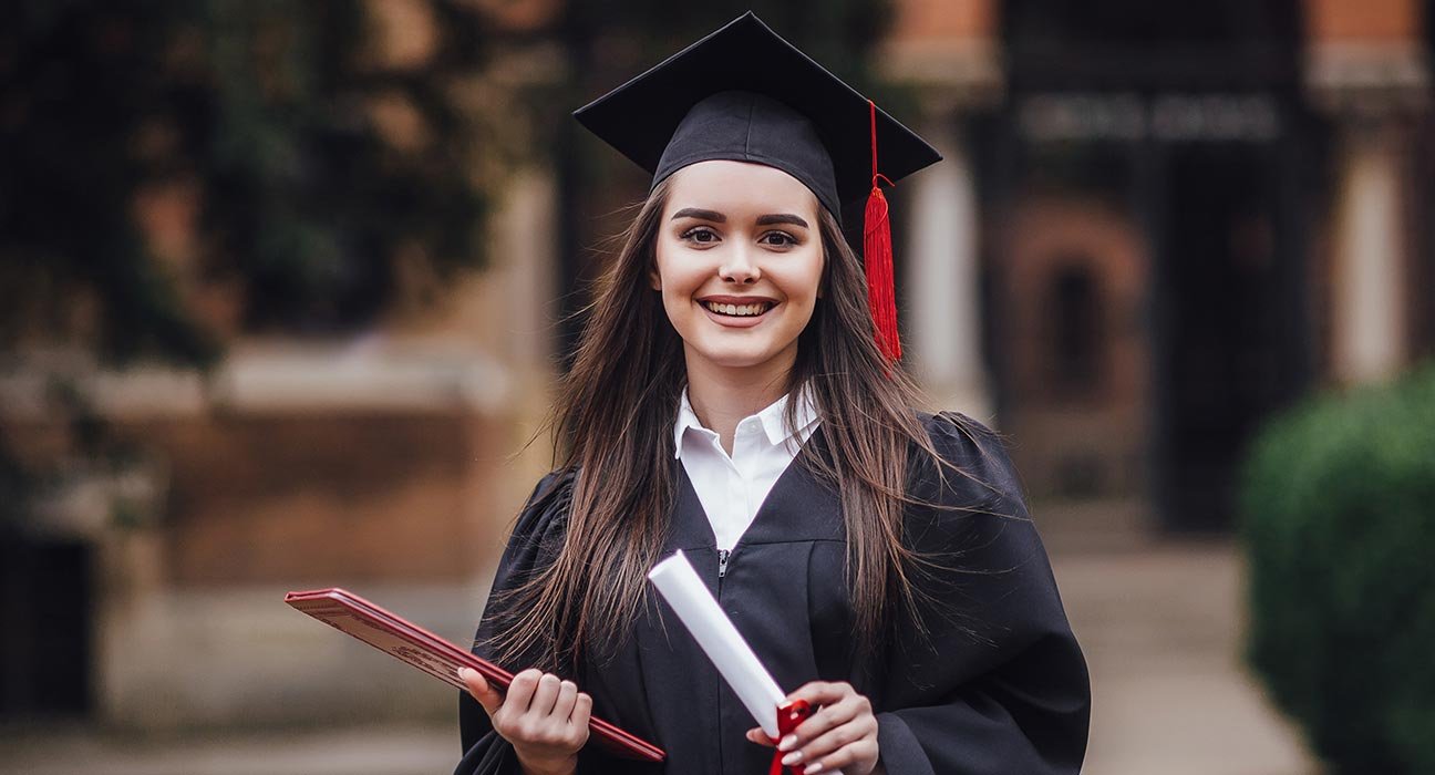 A girl standing with her degree