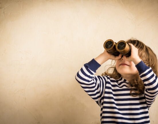happy kid looking ahead smiling child with spyglass travel adventure concept scaled