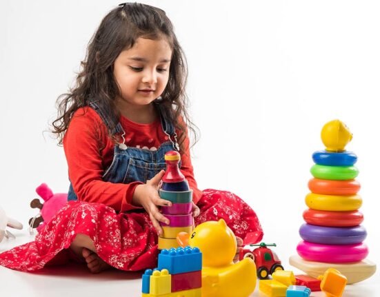 A cute girl playing with her toys