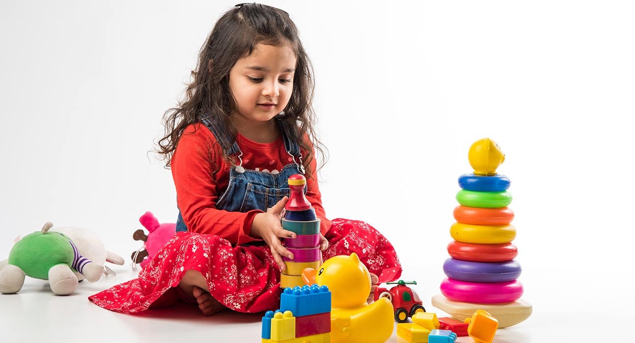 A cute girl playing with her toys