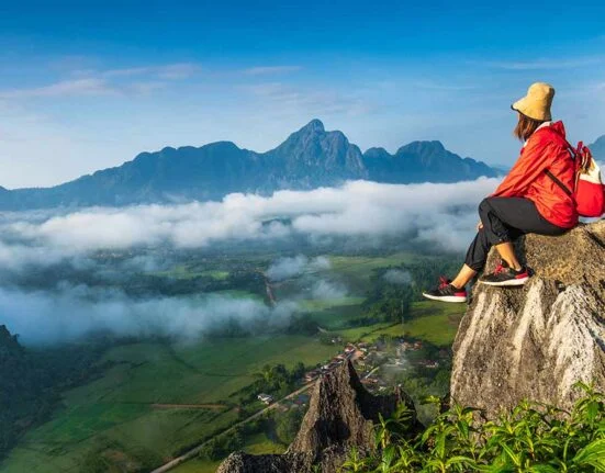 A girl sitting on hills and enjoying the view
