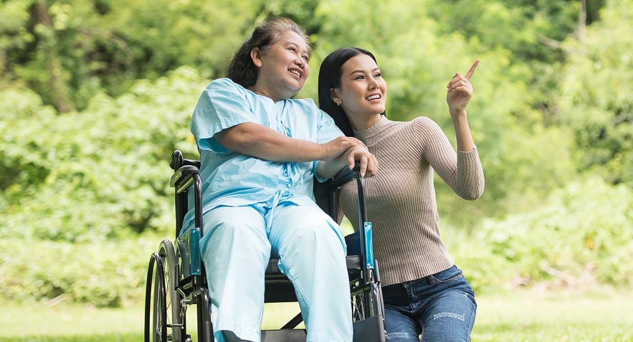 A lady on wheelchair with a girl