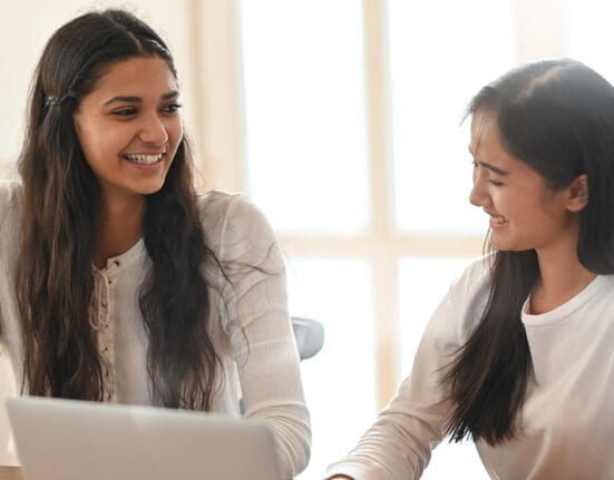 Two girls sitting together