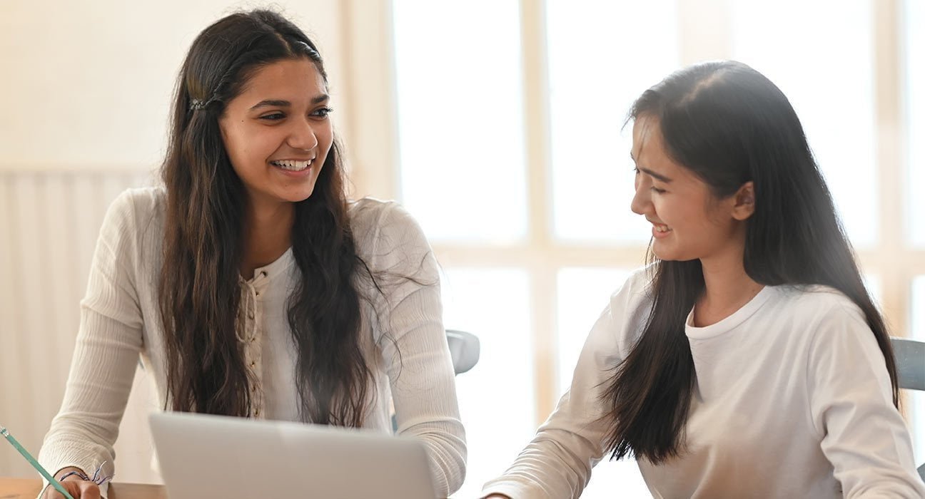 Two girls sitting together