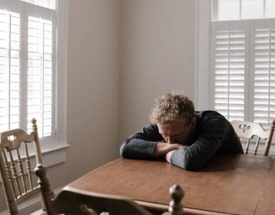 a sad man sitting on the chair