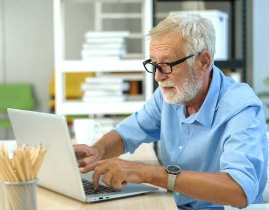 old man using laptop