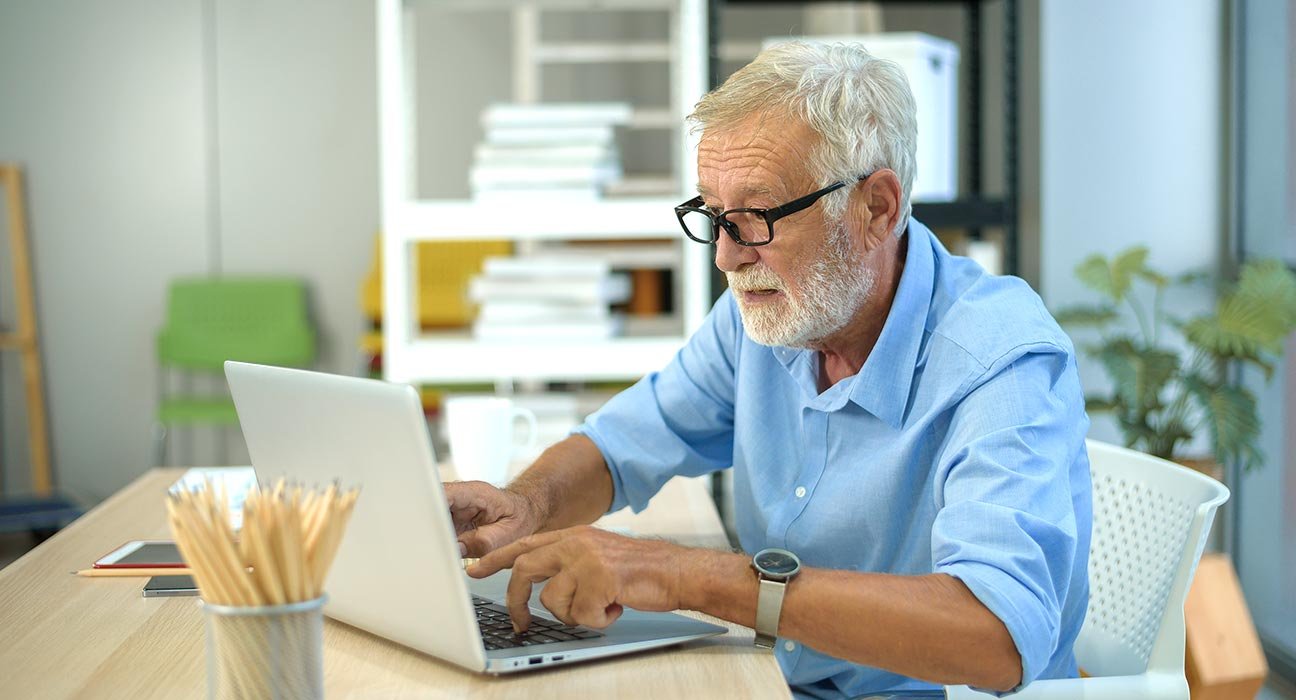 old man using laptop
